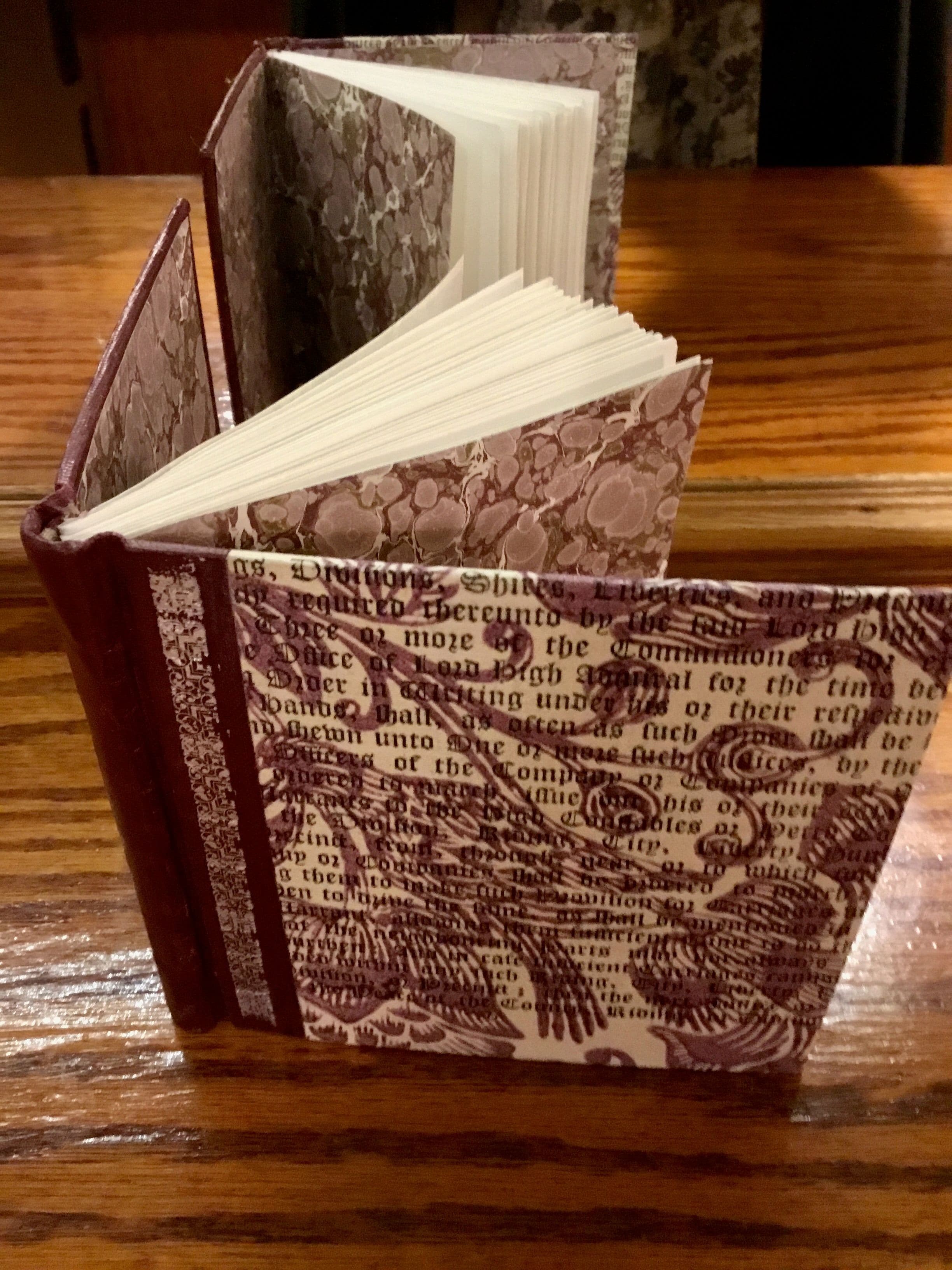 Green Chieftan goat, Hand dyed cameo, with gilt hot stamping and inlaid black leather title. Complimentary endpapers seleced in green black